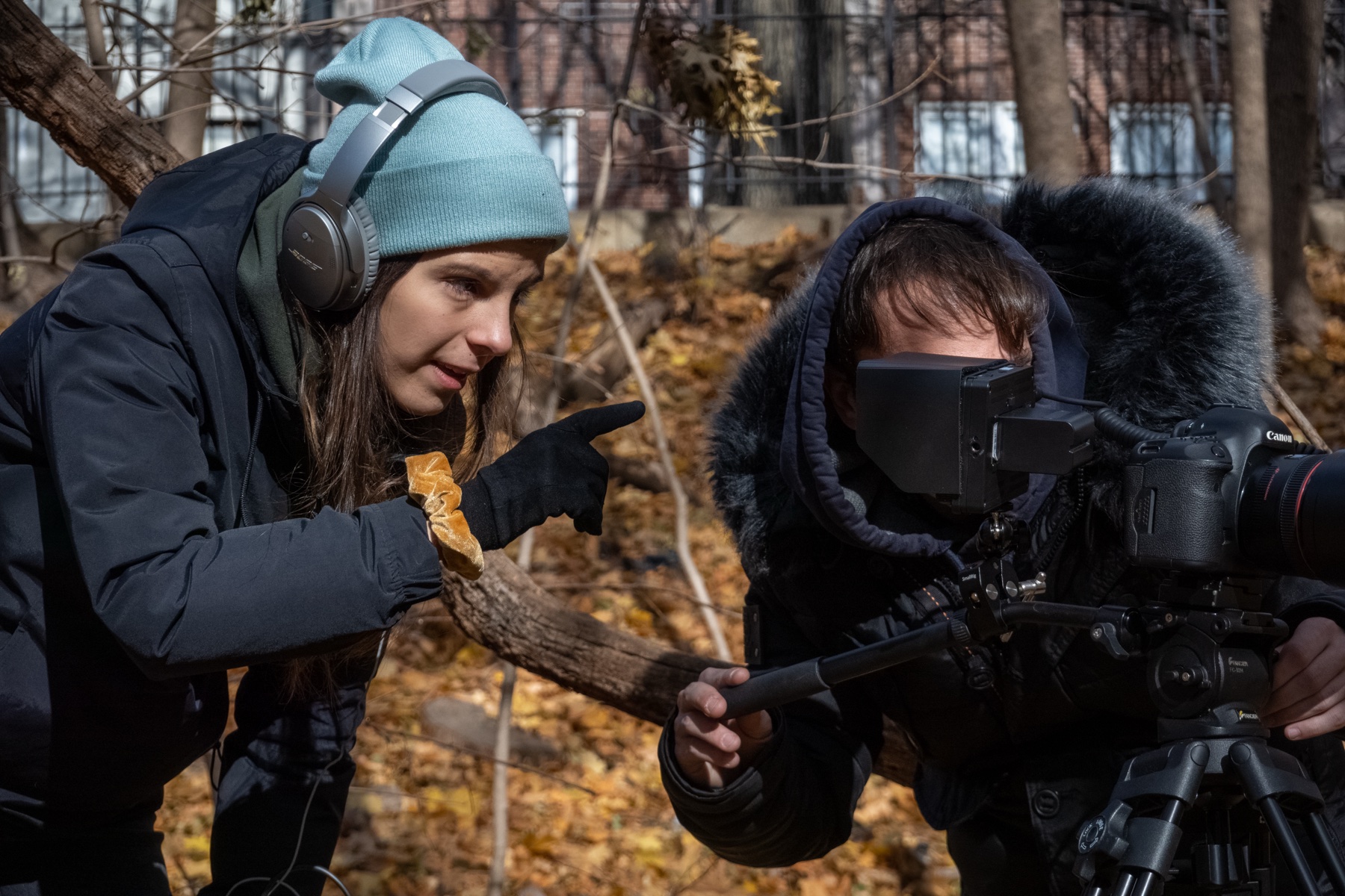 Chloé Latrech at monitor, pointing to the viewfinder while the operator frames the shot.
